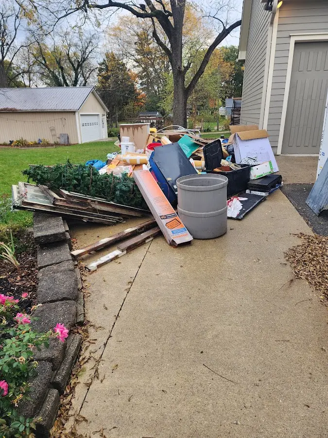 Dumpster being loaded with debris for Residential Dumpster Rental in Natchitoches
